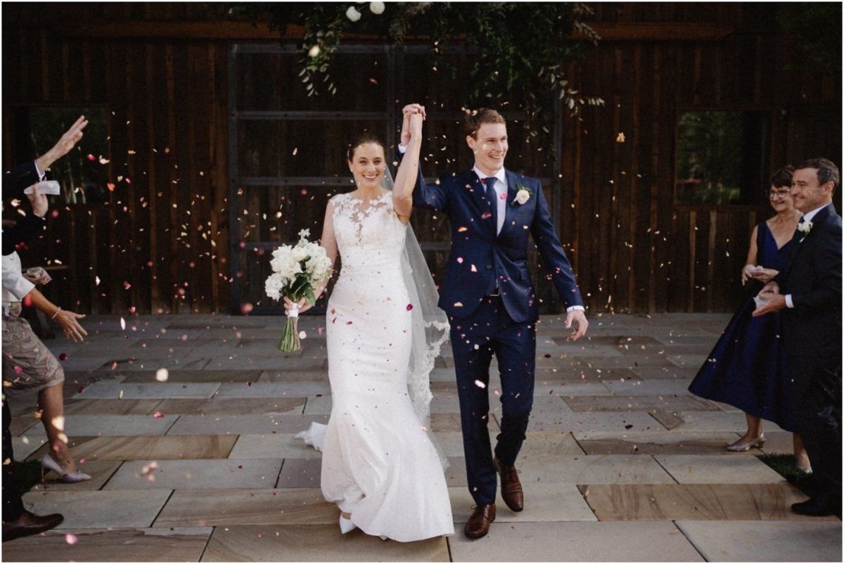 A bride and groom get showered with confetti after their Stables Bendooley Estate wedding